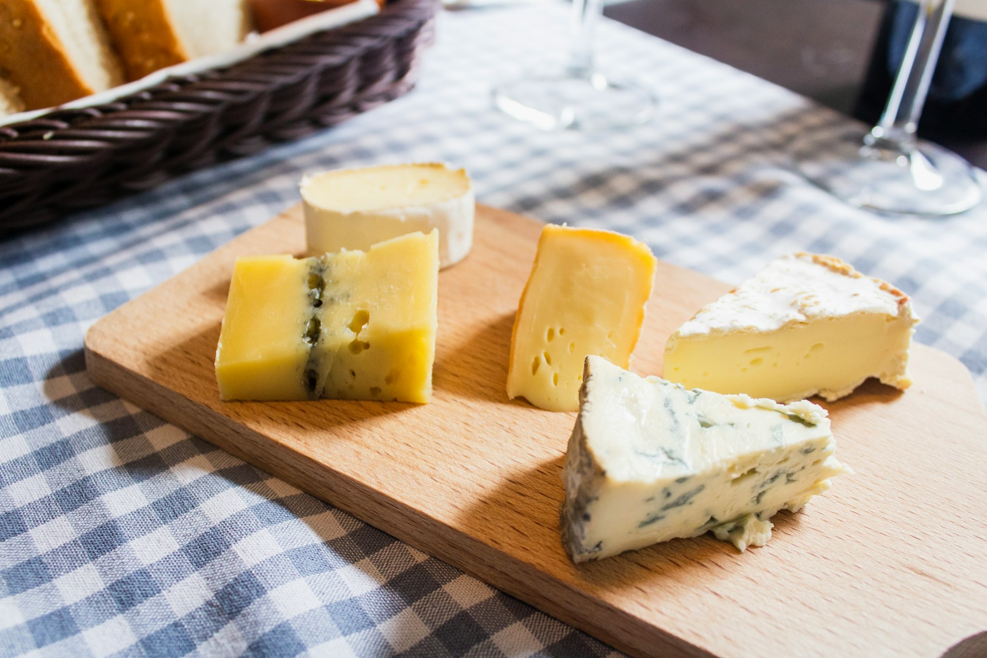 assorted cheeses on chopping board